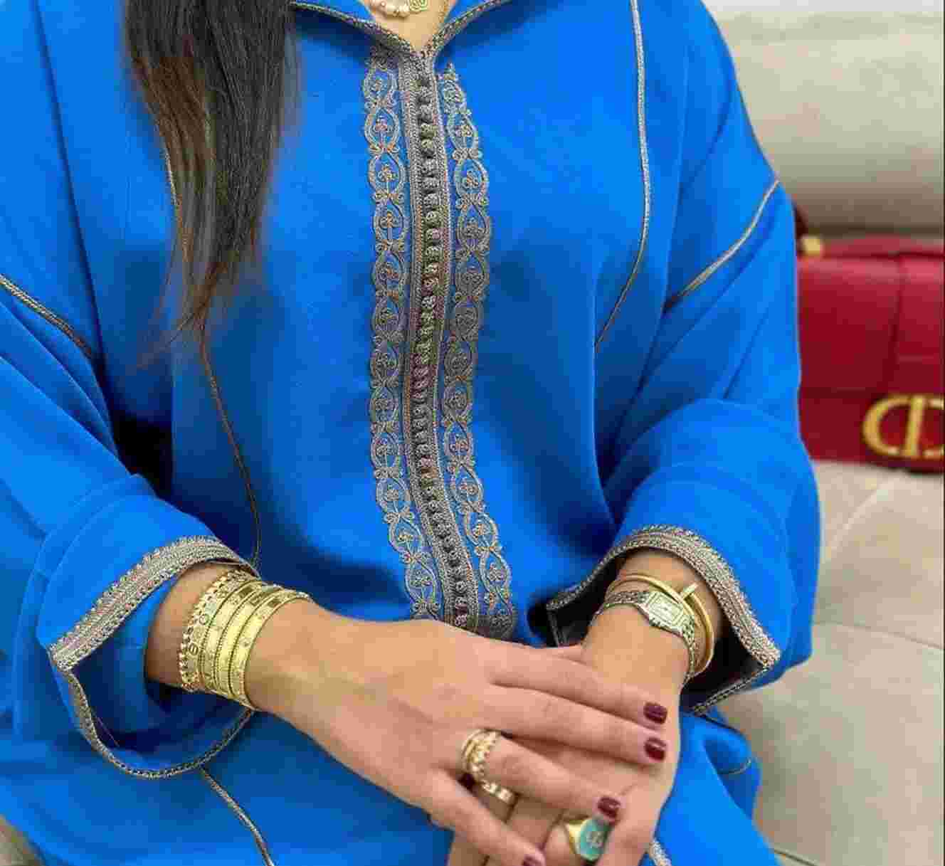 Moroccan woman wearing a traditional Moroccan women’s djellaba with embroidery and hood